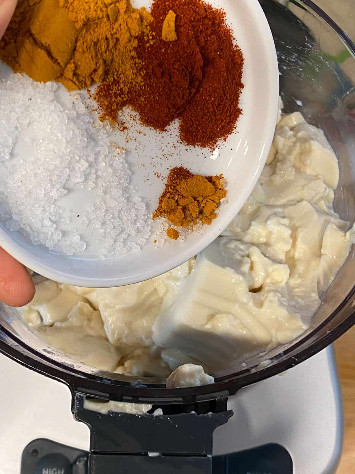 process shot of adding spices to blender