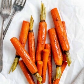 completed glazed carrots against a white surface