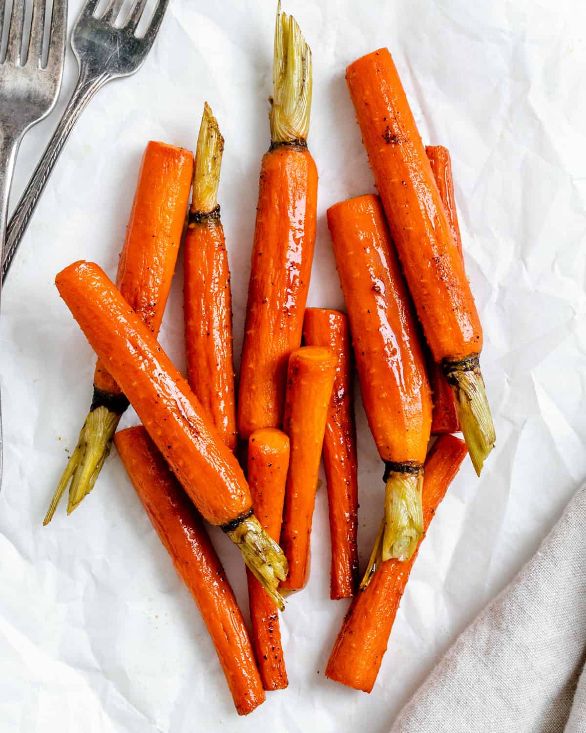 completed glazed carrots against a white surface 