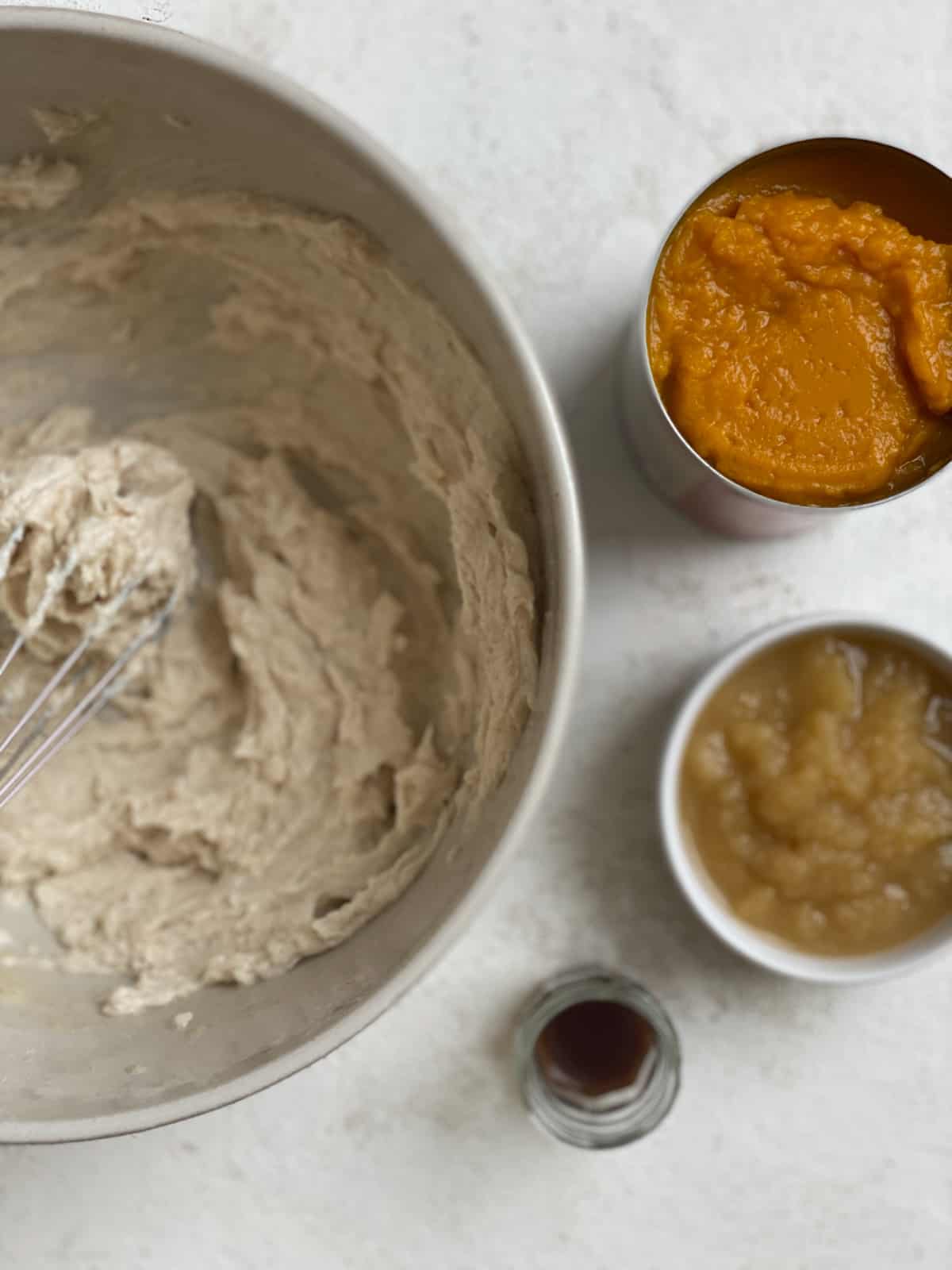 creamed vegan butter mixture in a bowl alongside ingredients for Vegan Pumpkin Chocolate Chip Cookies