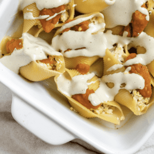 completed Pumpkin Stuffed Shells With Sage Cream in a white baking tray