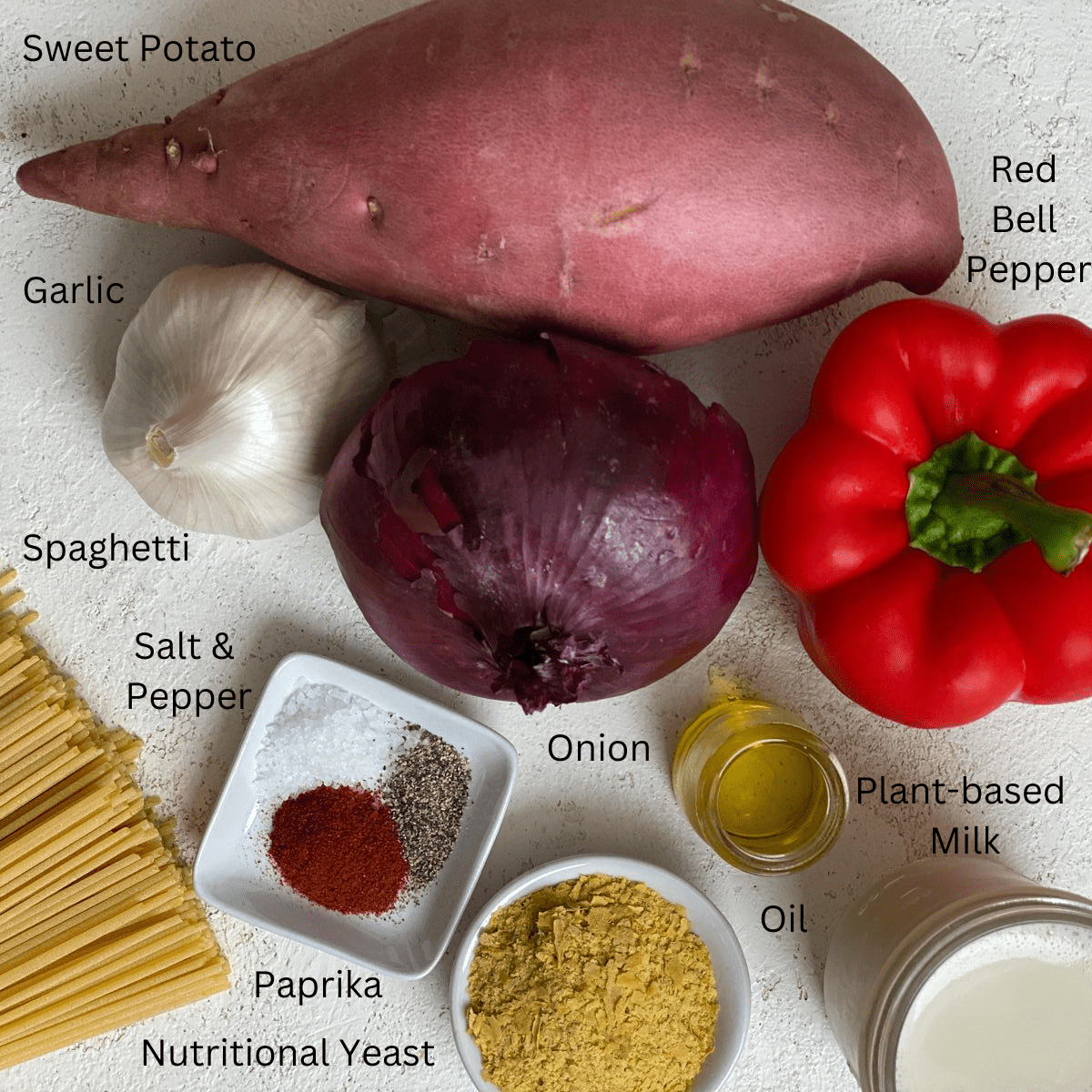 ingredients for Sweet Potato Pasta Sauce with Spaghetti measured out against a white surface