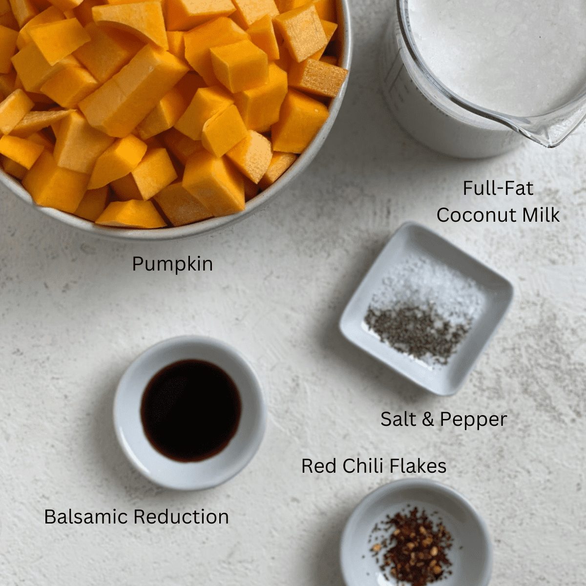 ingredients for Easy Vegan Pumpkin Soup measured out against a white surface