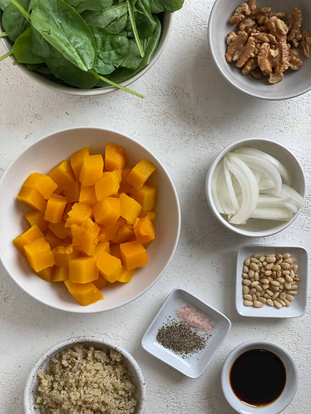 ingredients for Fall Roasted Pumpkin Salad against a white surface