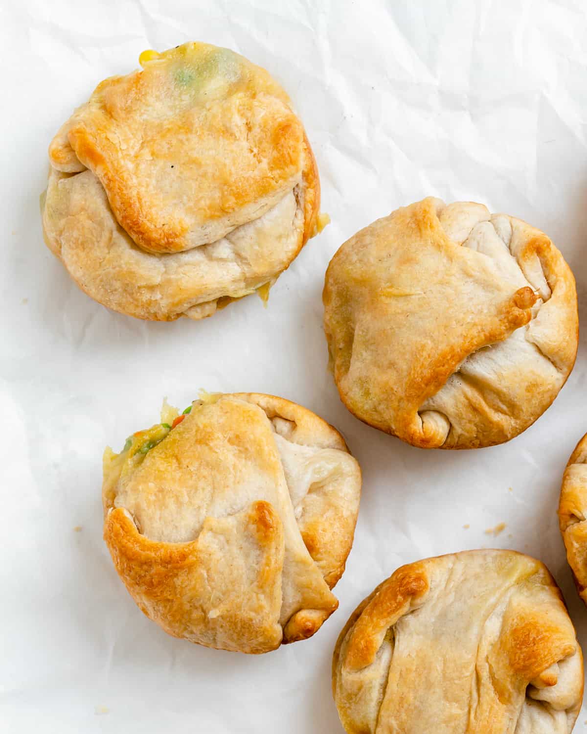 completed Mini Vegan Pot Pies scattered on a white surface