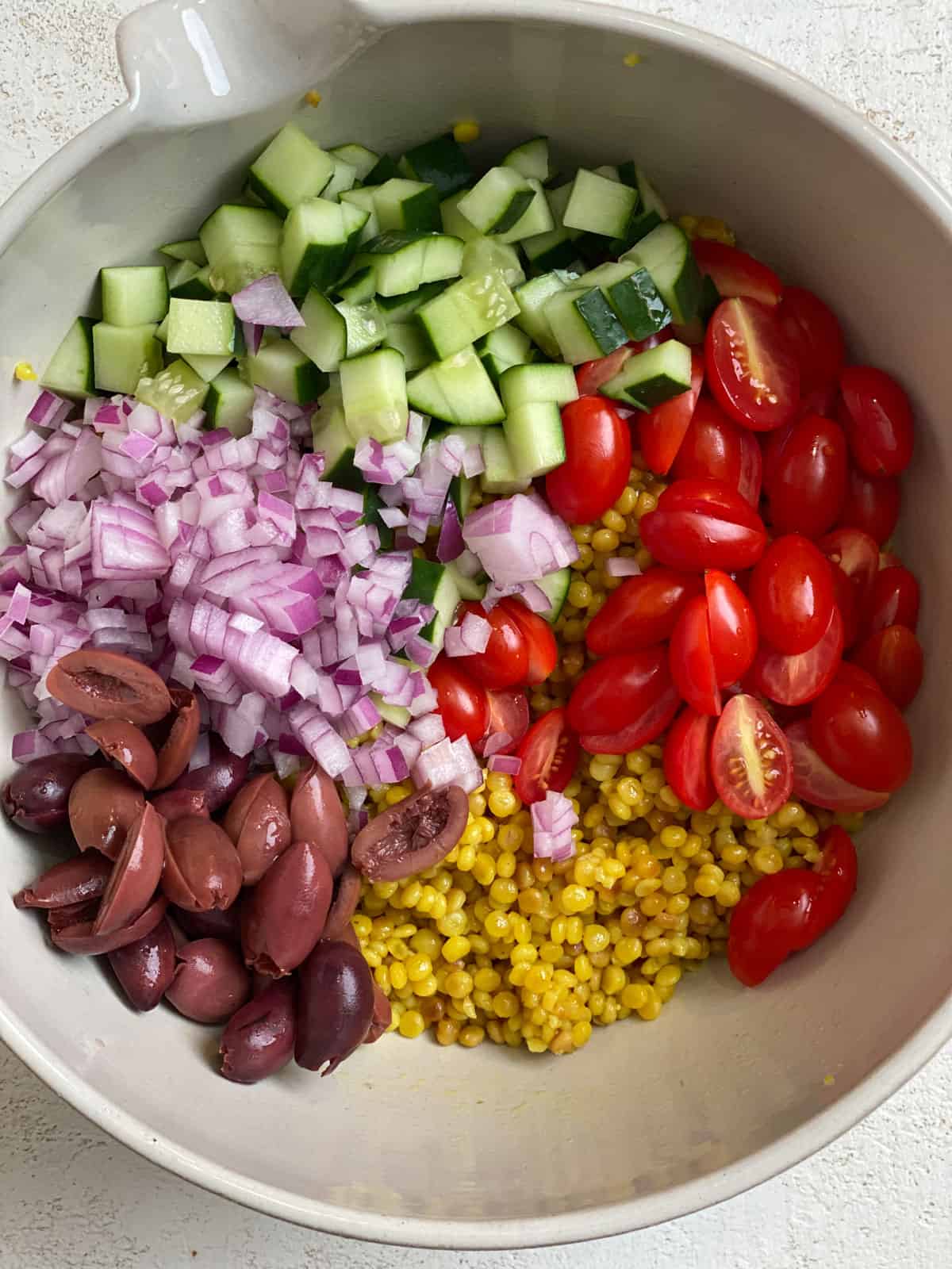 ingredients for Mediterranean Pearl Couscous Salad in a pan