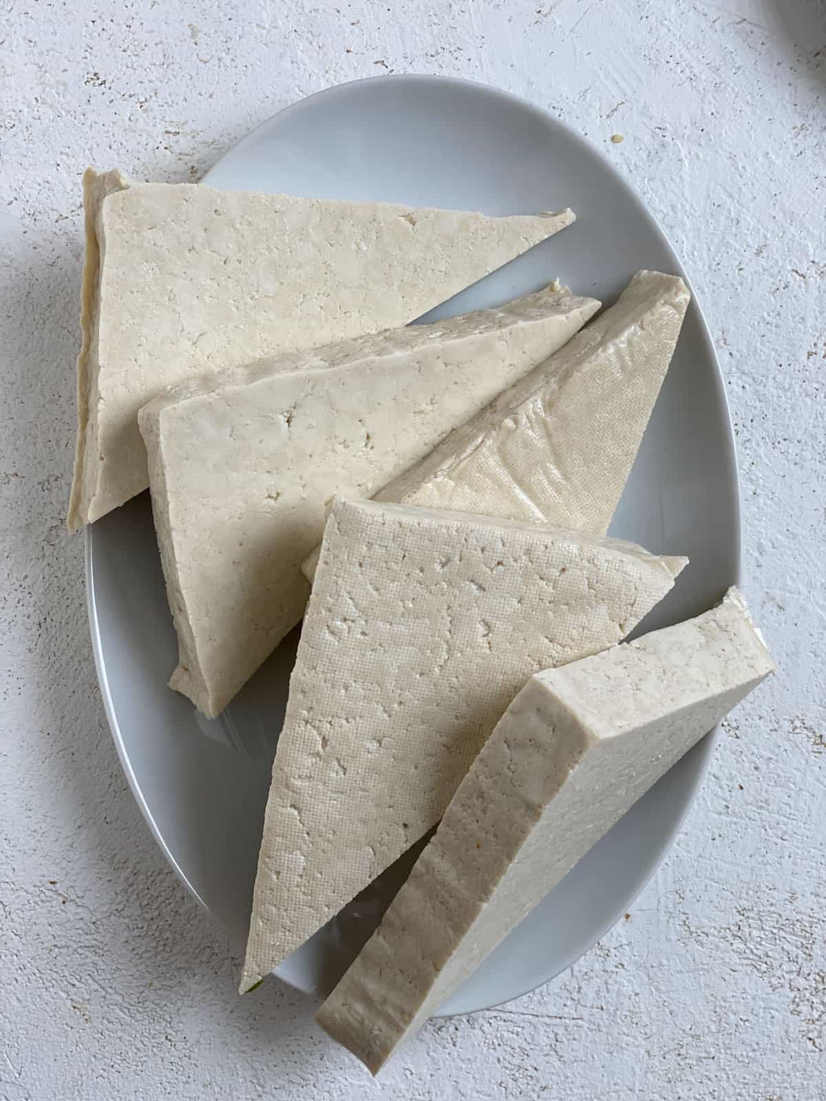 slices of tofu plated on a white plate