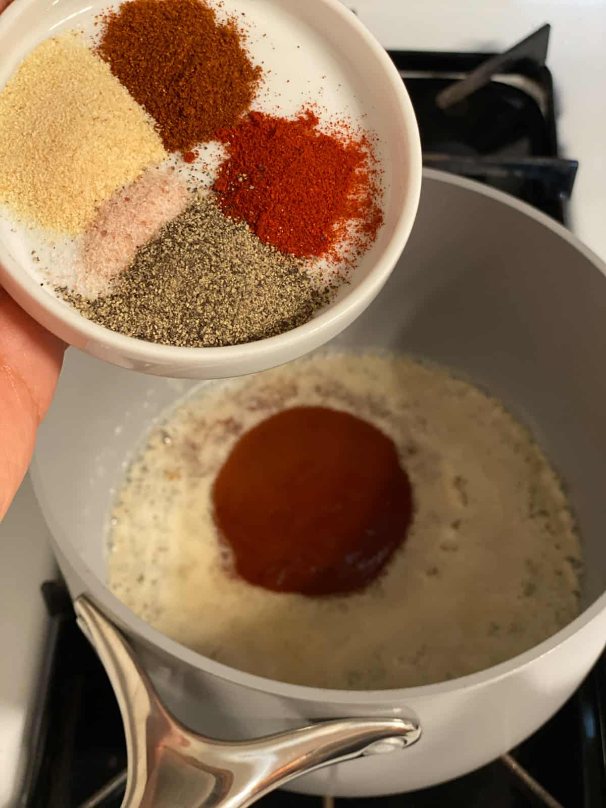 process shot of adding spices to pan