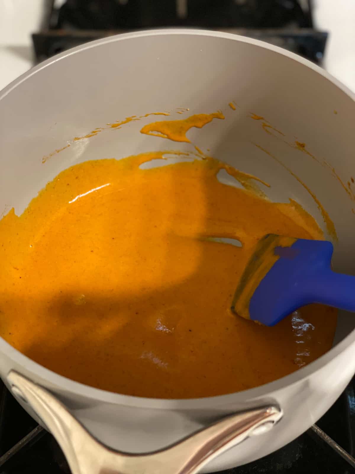 process shot of mixing sauce together in pan