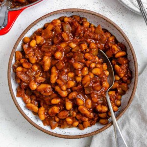completed Homemade Vegan Baked Beans [Boston Style] plated in a bowl against a light surface