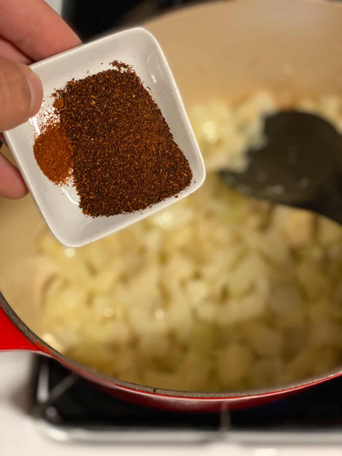 process shot of adding seasoning to pan