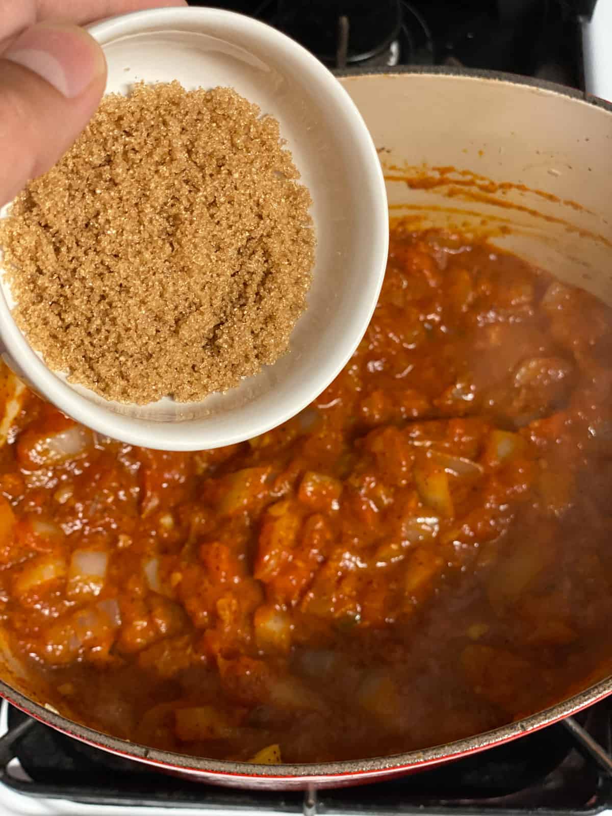 process shot of adding brown sugar to pan