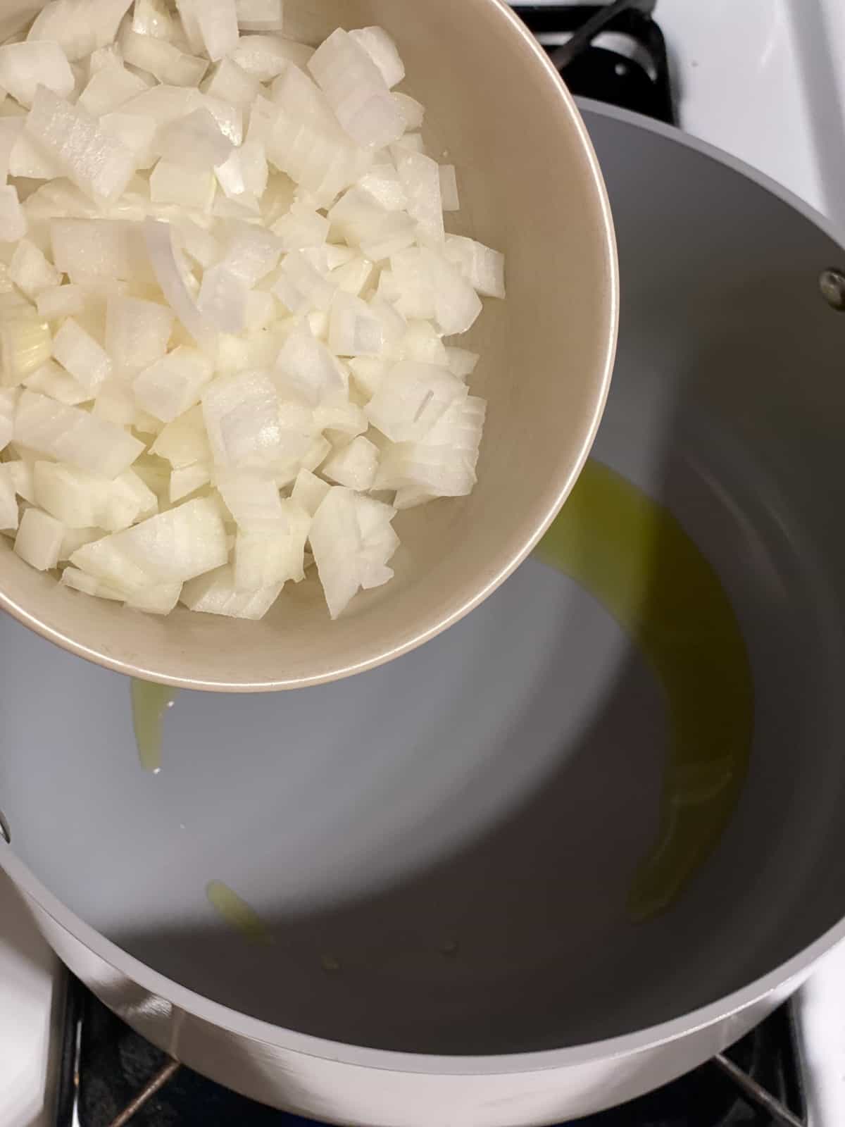 process shot of adding onions to pan