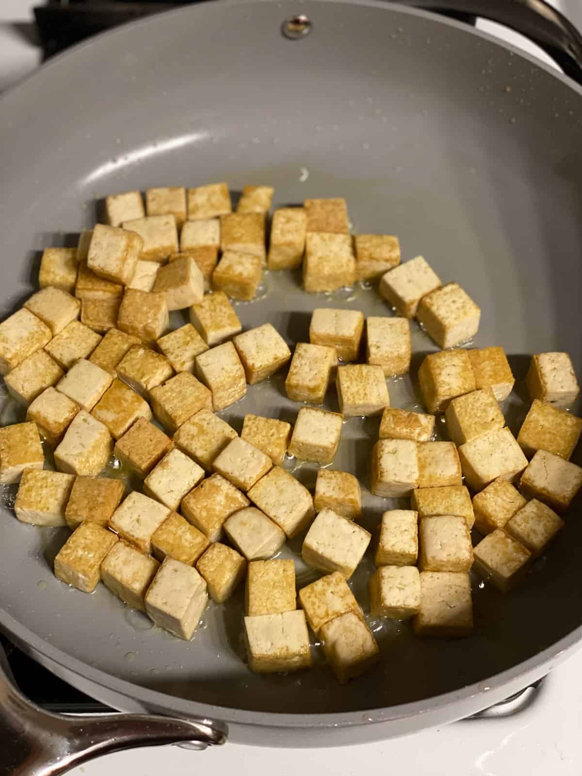process shot of cooking tofu in a pan