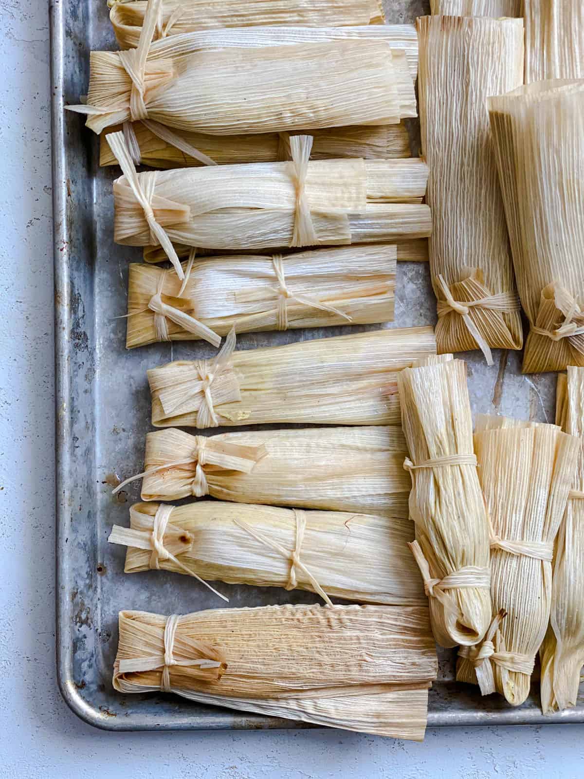 several pre cooked tamales in a baking dish