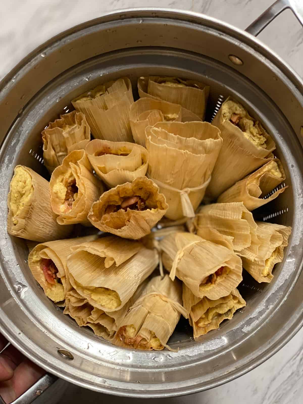 process shot showing tamales in a large pot