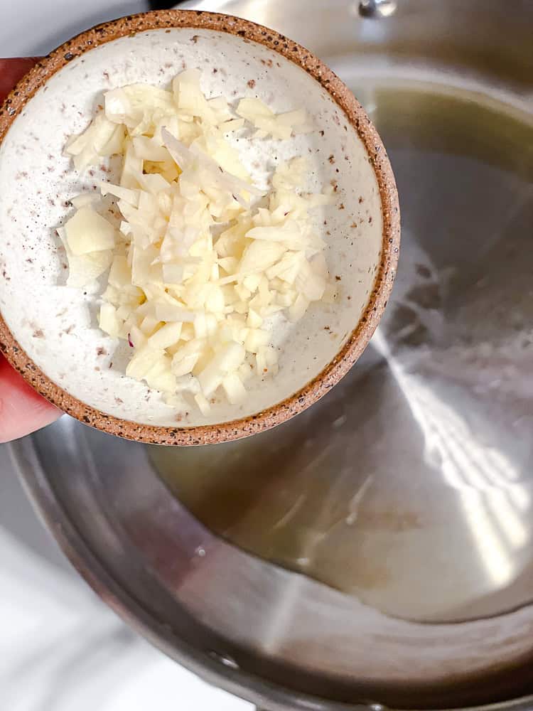 process shot of adding garlic to pan