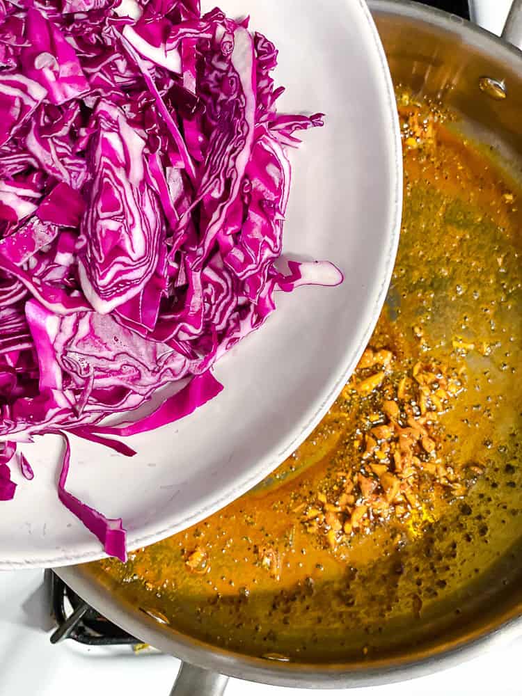 process shot of adding cabbage to pan