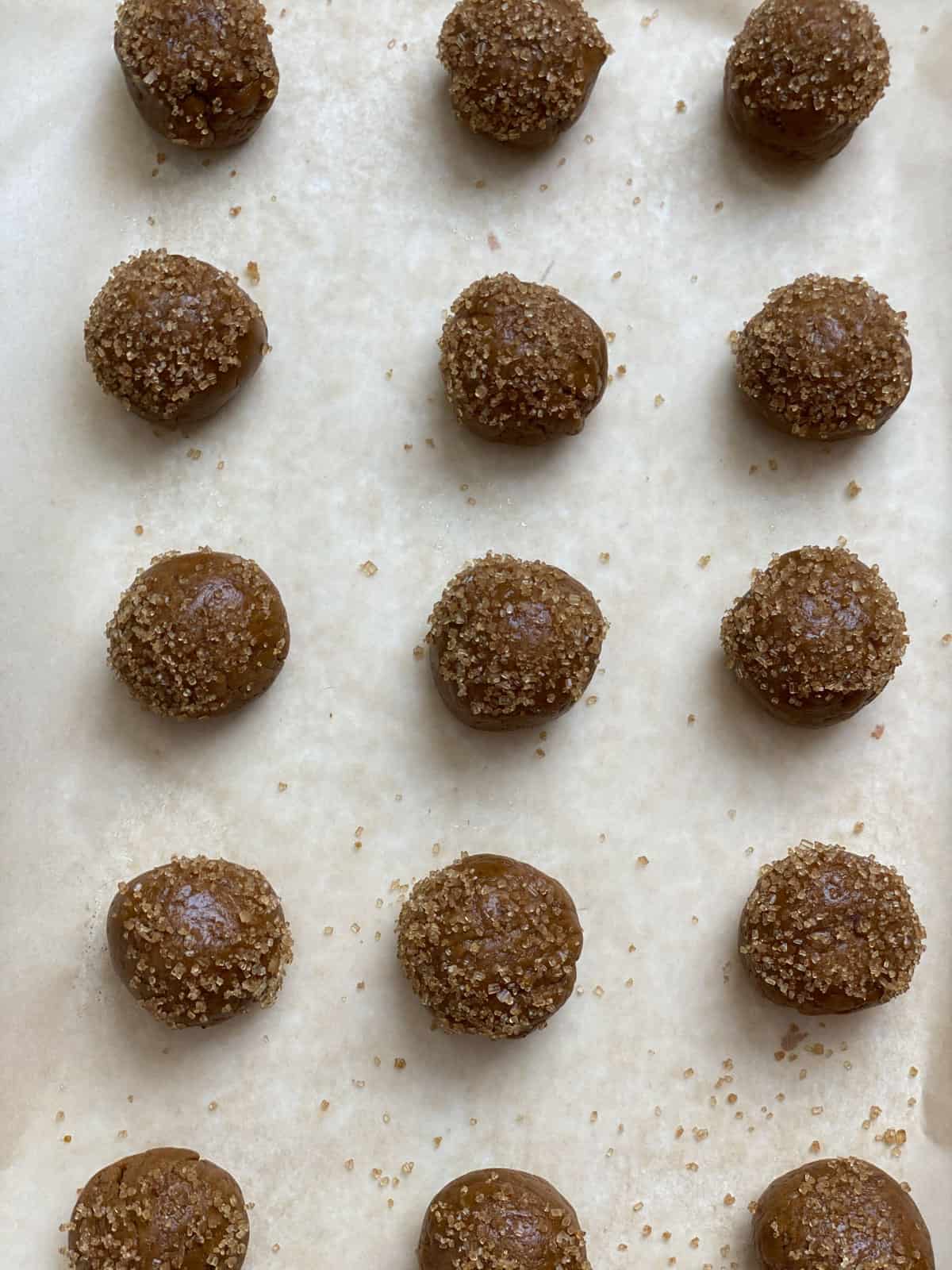 pre baked cookie dough balls lined up on baking tray