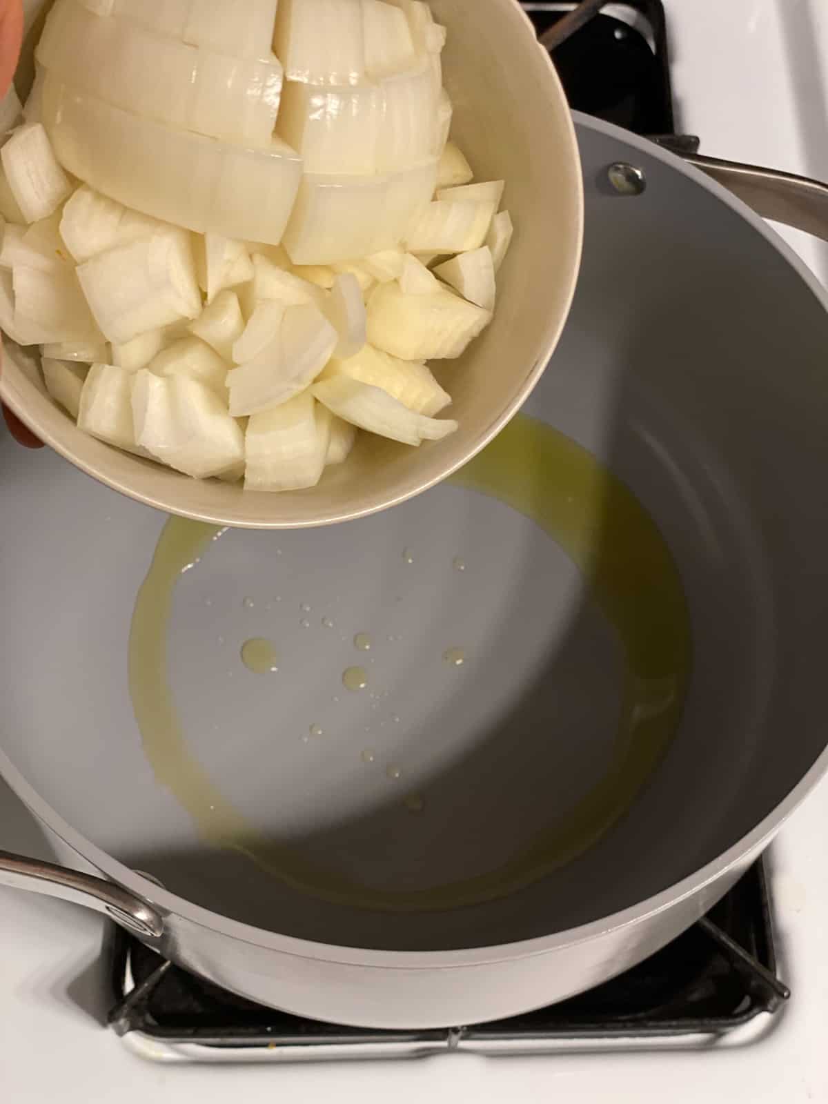 process shot of adding onion to pot