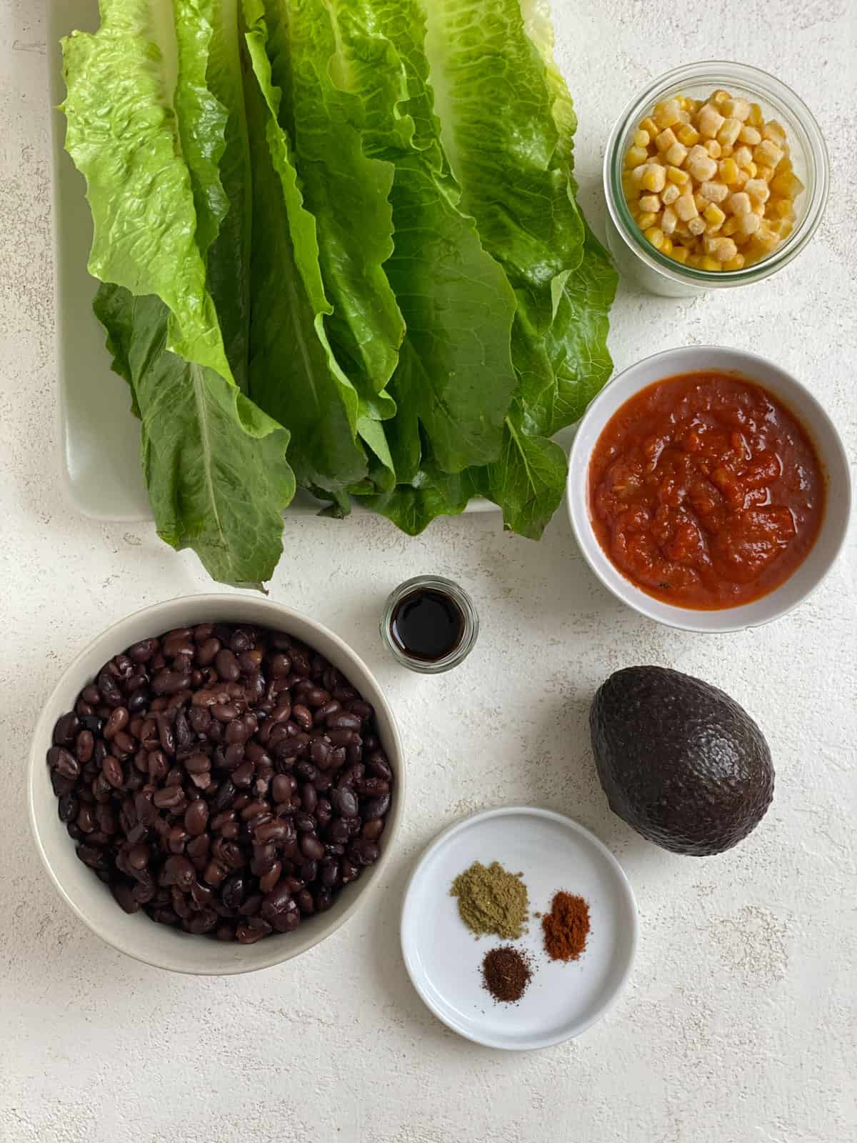 ingredients for Vegan Black Bean Lettuce Wraps measured out against a white surface