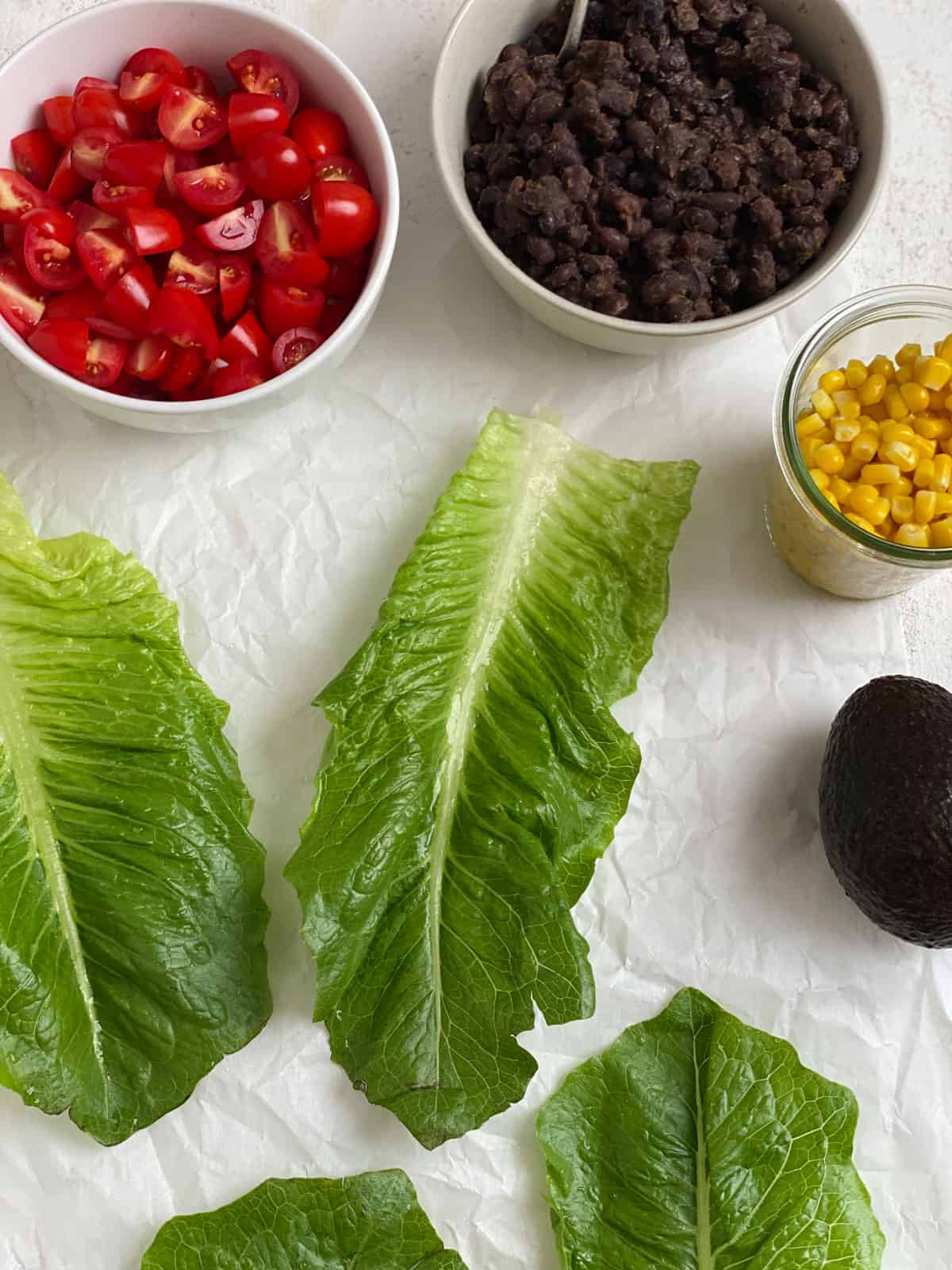 ingredients for Vegan Black Bean Lettuce Wraps measured out against a white surface