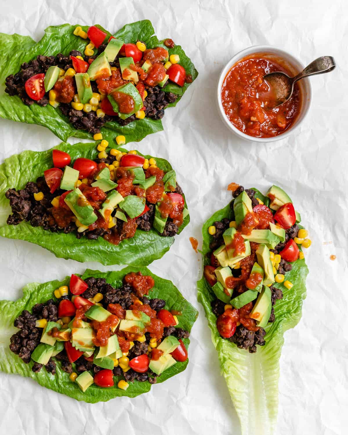completed Vegan Black Bean Lettuce Wraps against a white surface
