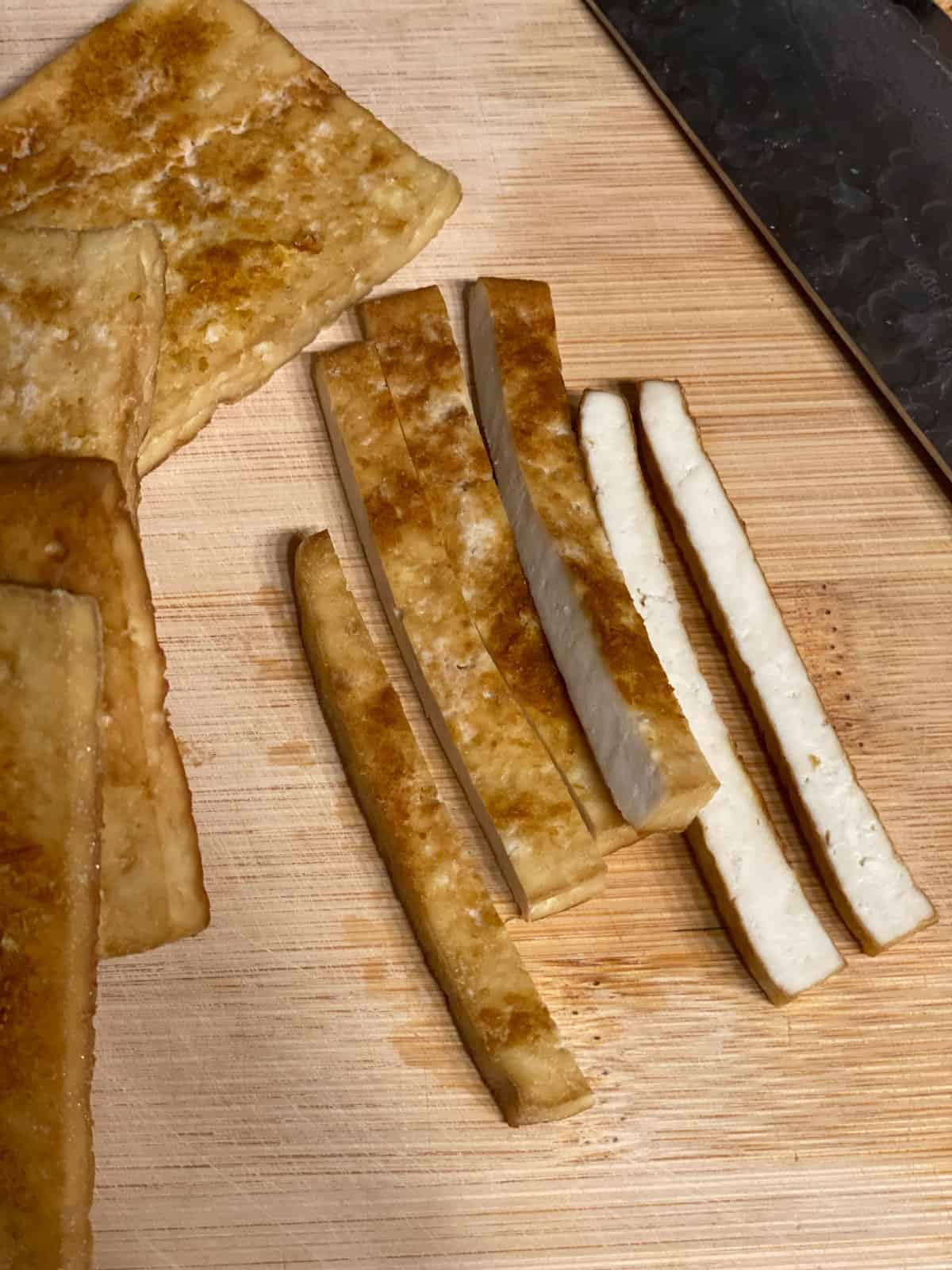 process shot of further slicing tofu into strips