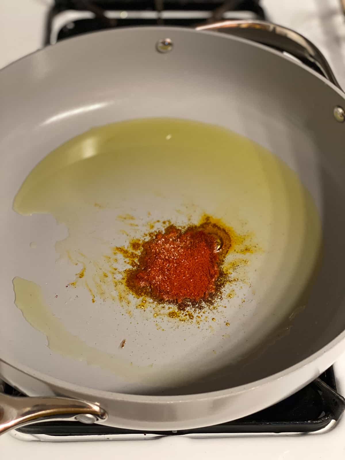 process shot of adding paprika to pan