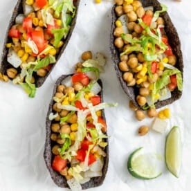 three completed Potato and Chickpea Tacos on a white surface
