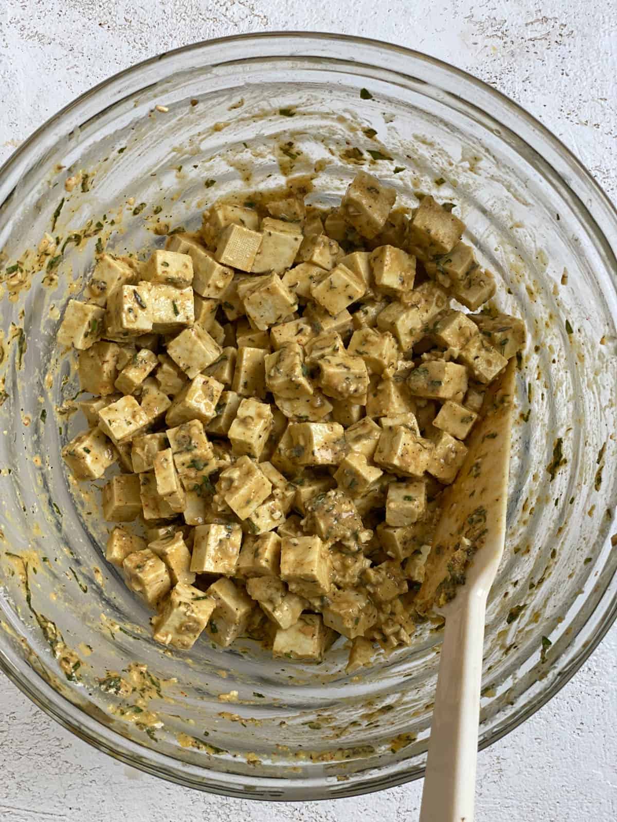 process shot of mixing tofu mixture in a bowl