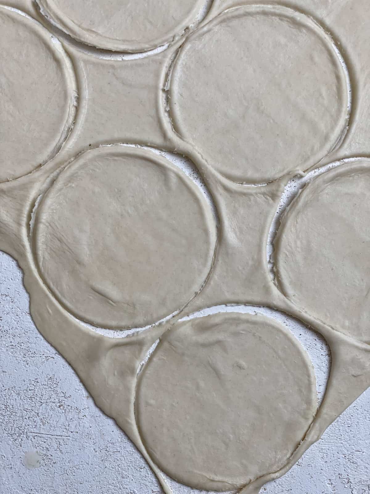 process shot of making circular pieces of dough