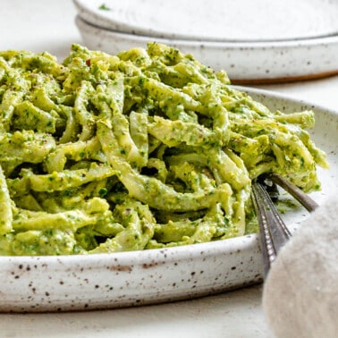 completed Amazing Avocado Pesto Pasta plated against a light surface