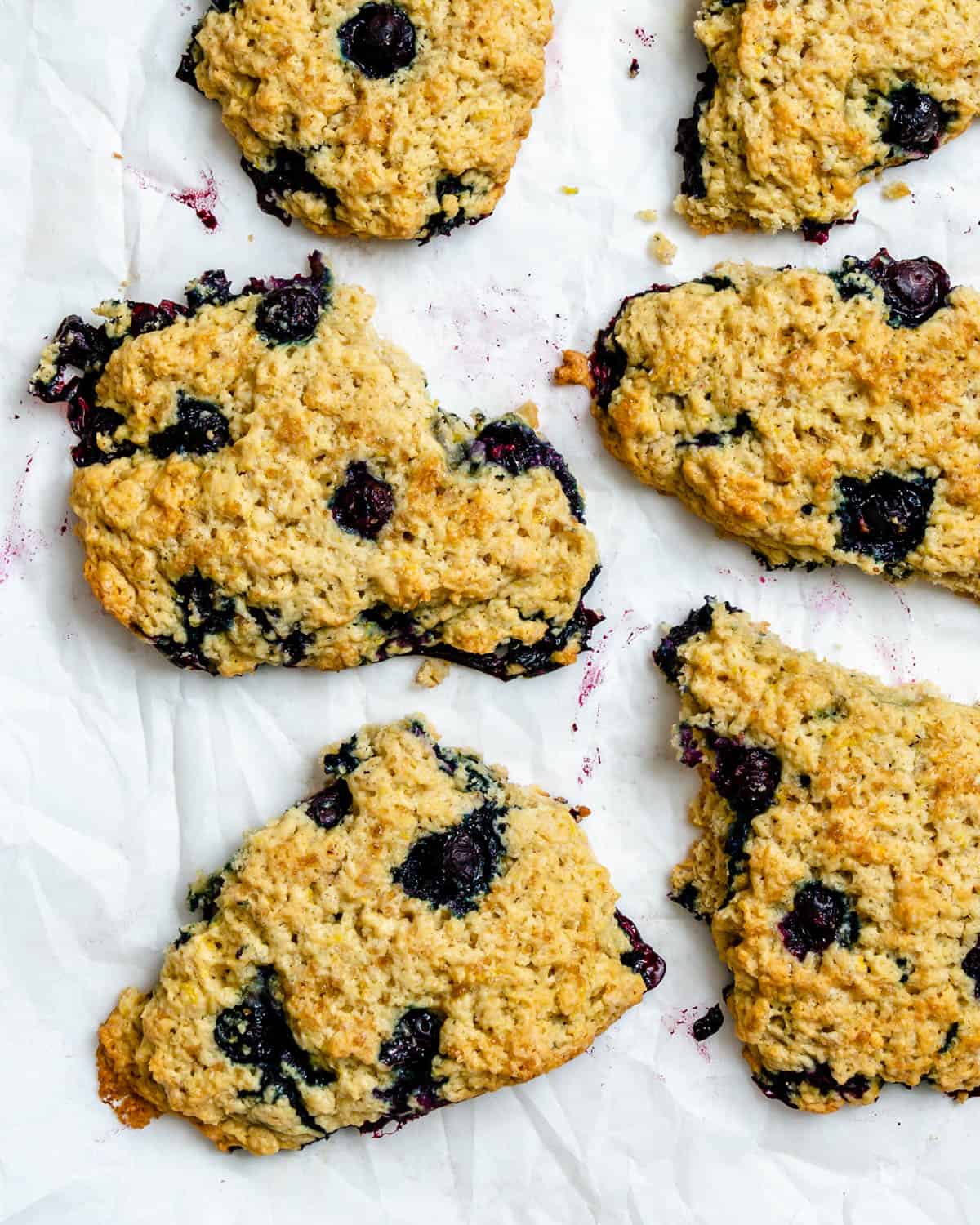 completed Vegan Lemon Blueberry Scones scattered on a white surface