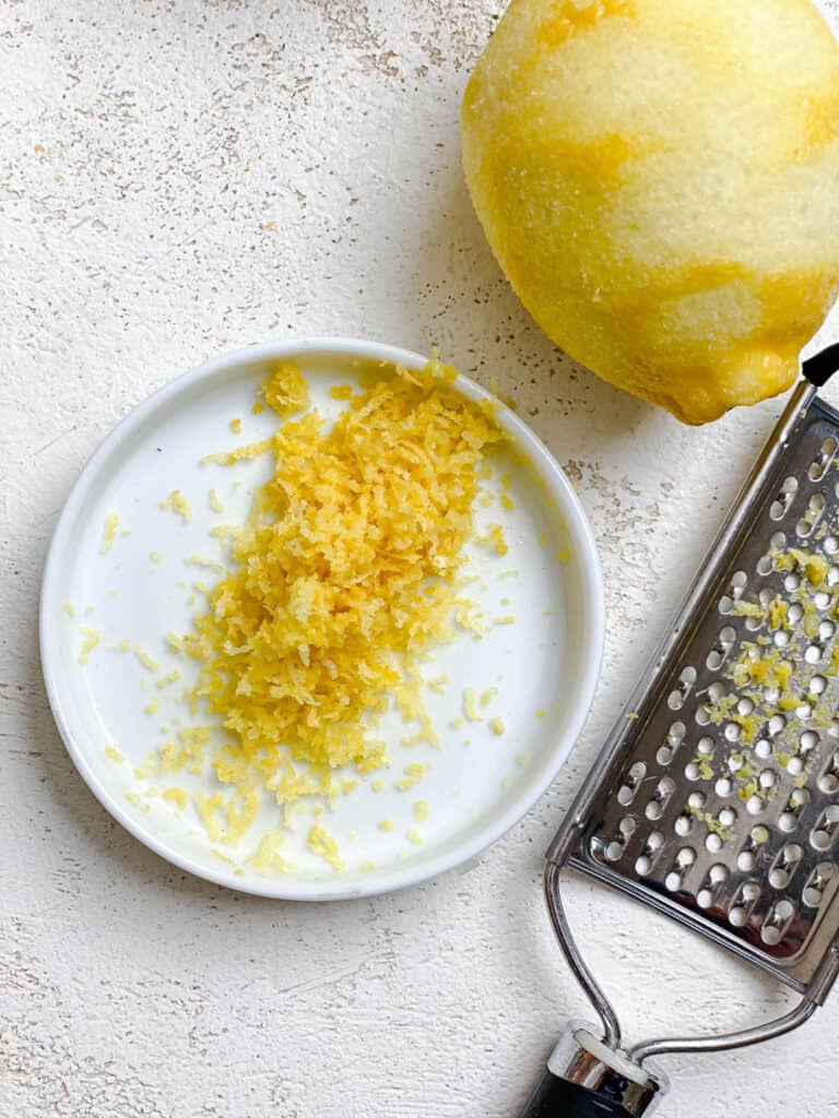 process shot showing lemon post zesting on a small plate
