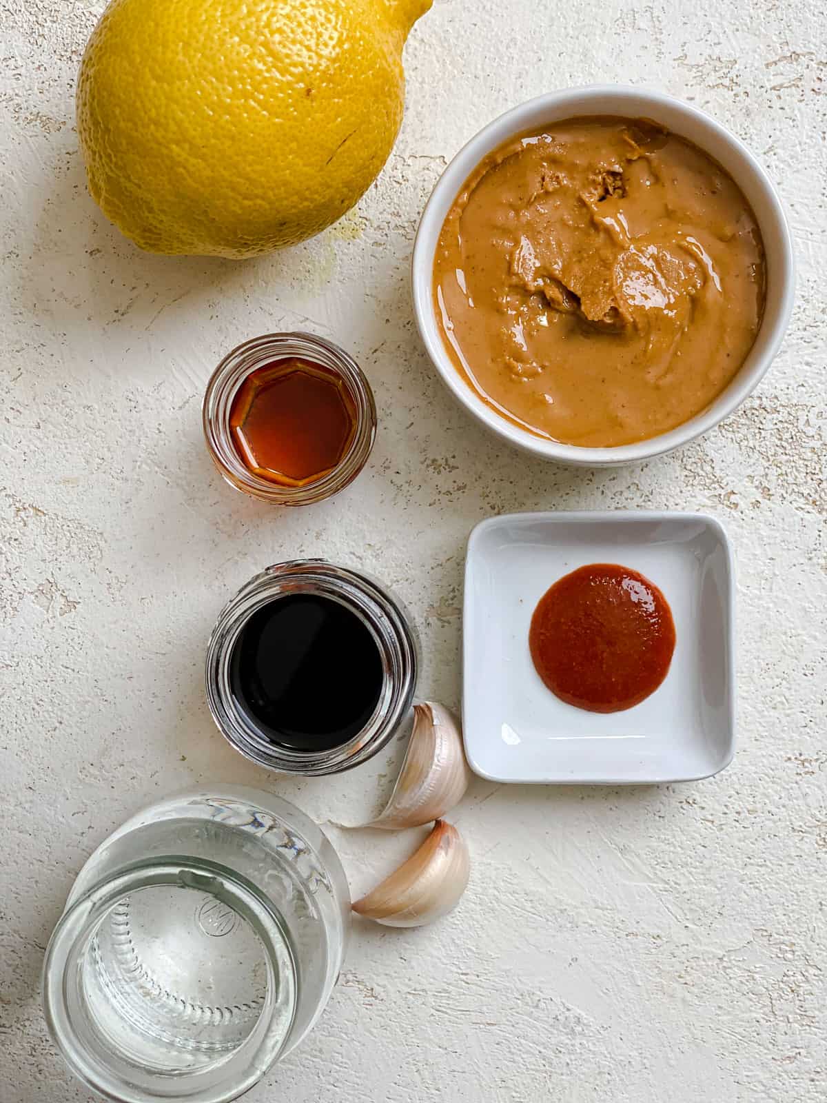 ingredients for Spicy Peanut Dipping Sauce measured out against a light surface
