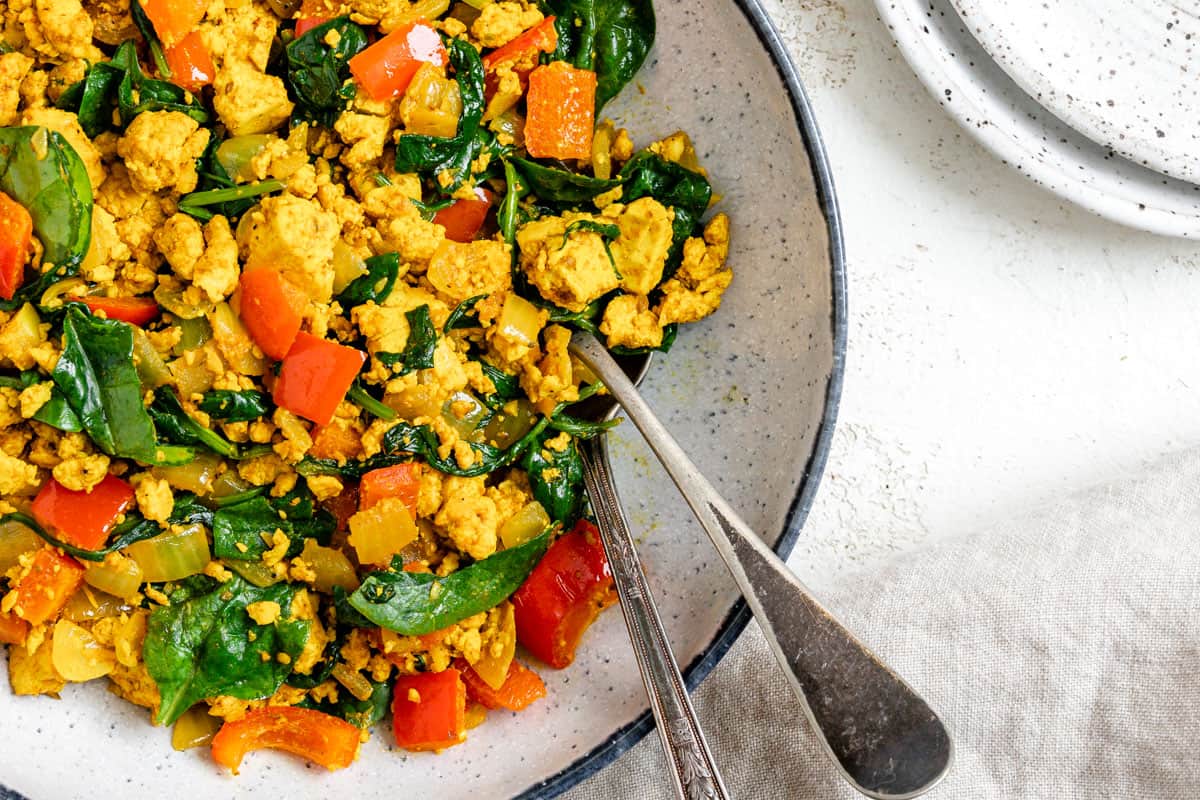 completed The Best Vegan Tofu Scramble with Veggies plated on a plate against a light background