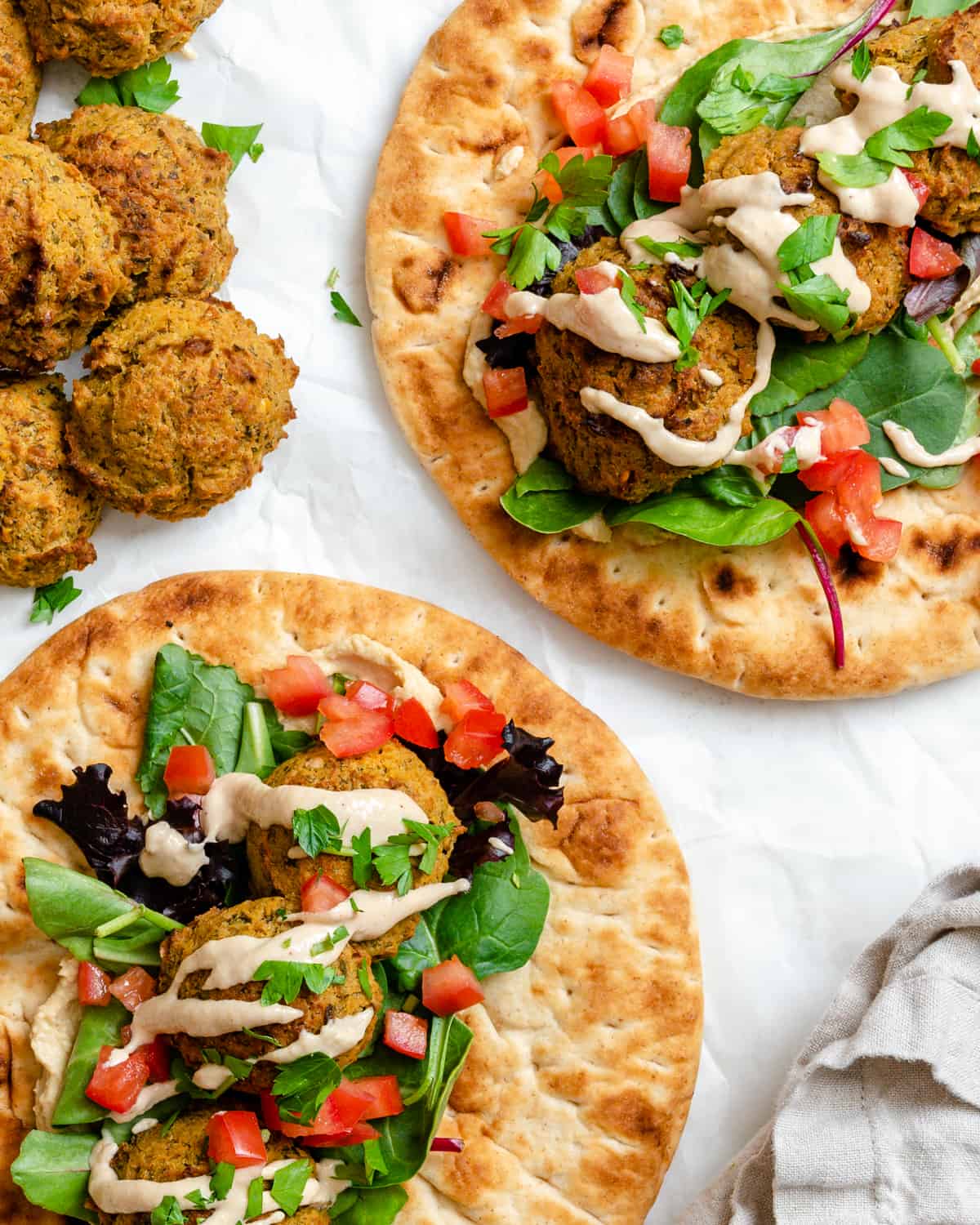 completed Healthy Baked Falafel on bread against a white background