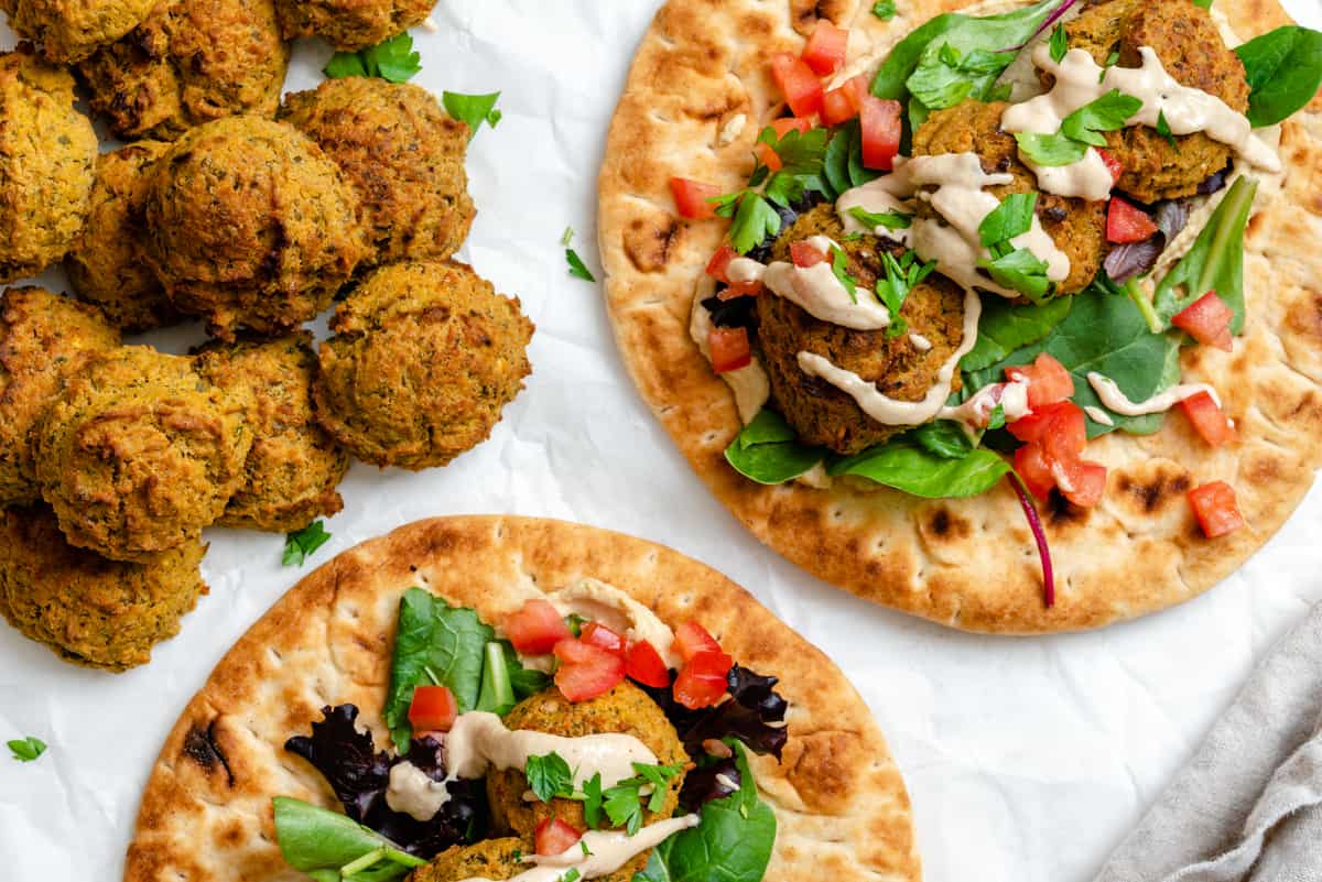 completed Healthy Baked Falafel on bread against a white background
