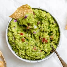 completed Easy Guacamole in a white bowl against a white background