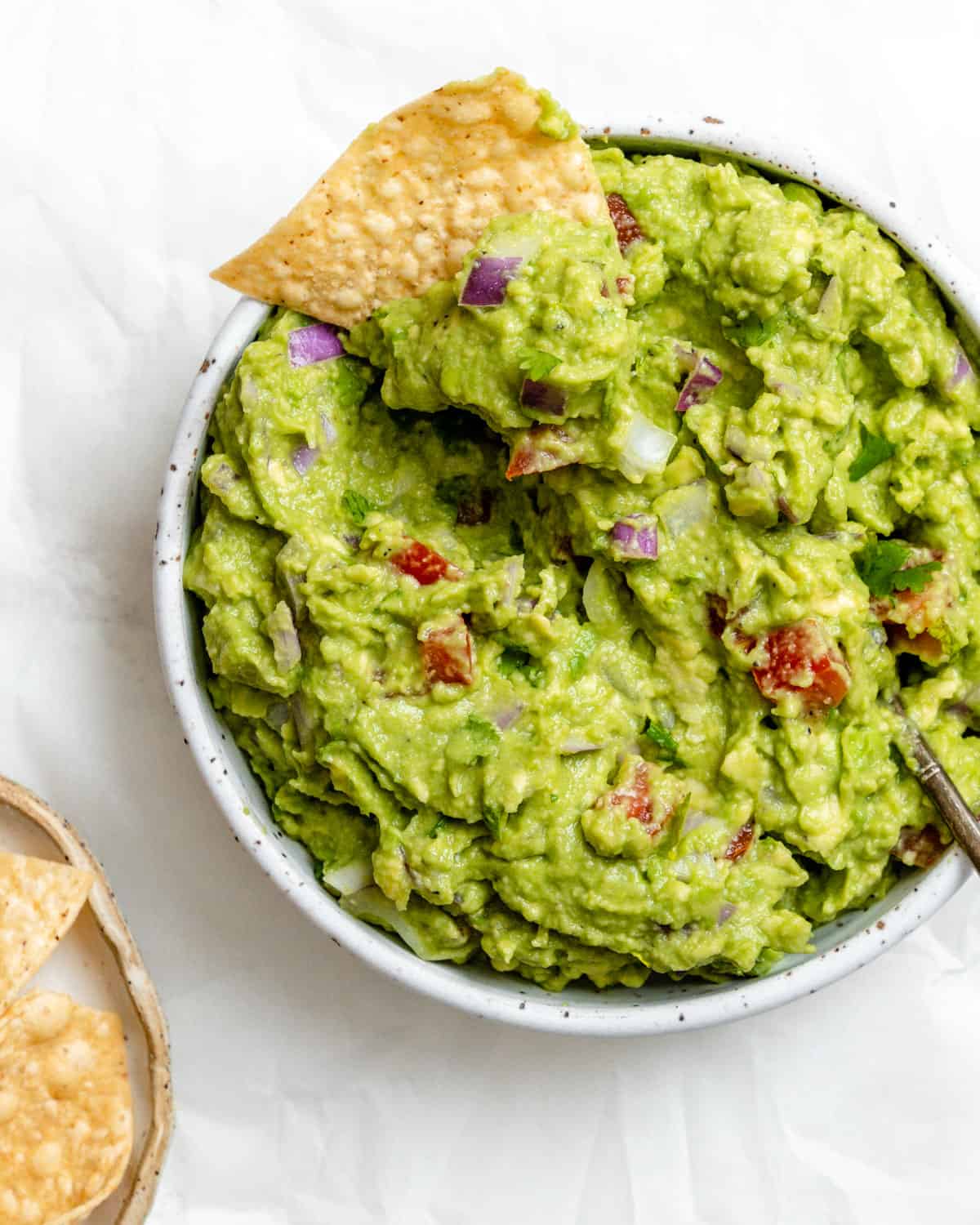 completed Easy Guacamole in a white bowl against a white background