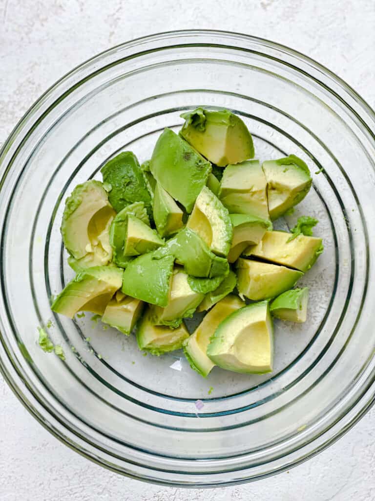 sliced avocados in a glass bowl