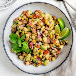 completed Texas Caviar [Avocado Corn and Bean Salad] in a white plate against a light background