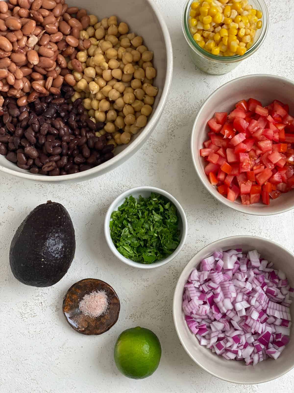 ingredients for Texas Caviar [Avocado Corn and Bean Salad] against a white background