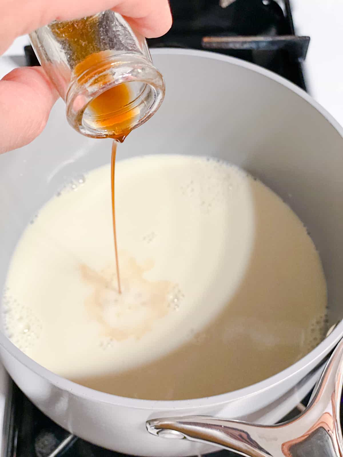 process shot of adding vanilla extract to pot