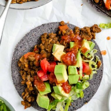 completed Lentil Tacos on a tortilla against a white background
