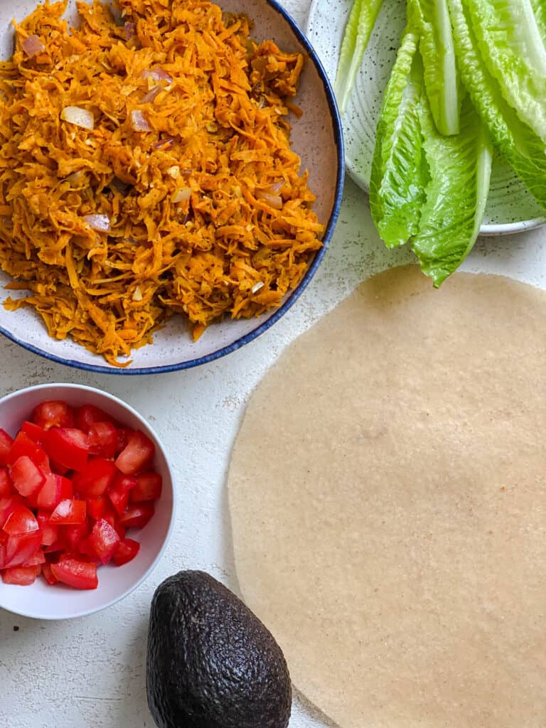 ingredients for Sweet Potato Burritos measured out against a white surface