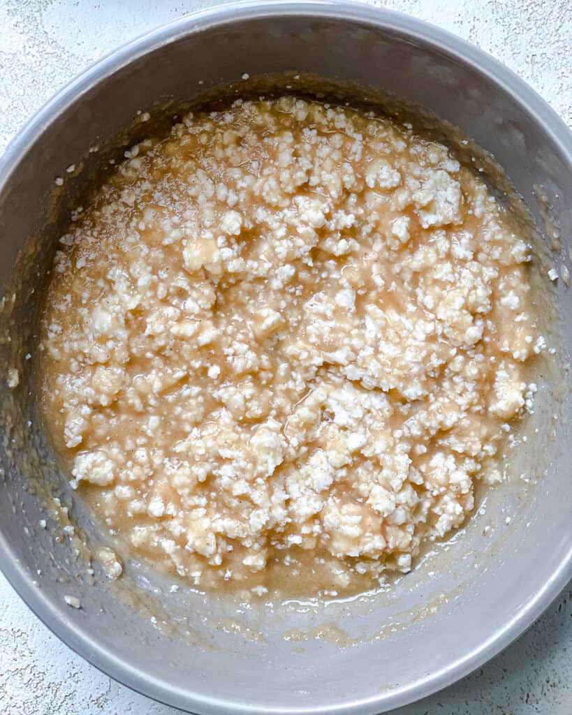 process shot of adding ingredients to a medium pan
