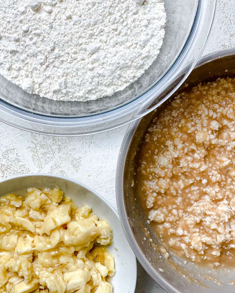 bowl of flour alongside batter and banana