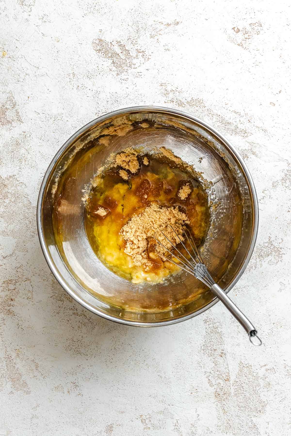 Process shot showing mixing ingredients together in a bowl.